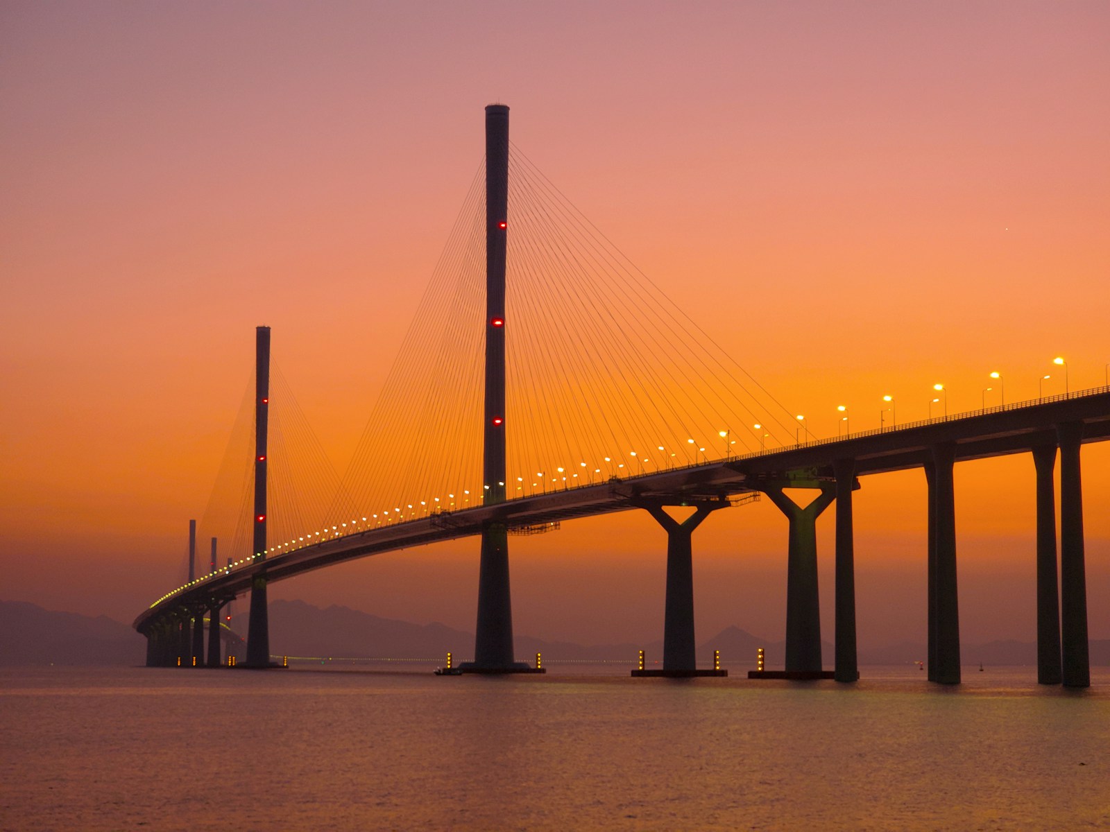 Cable-stayed bridge over water at sunset